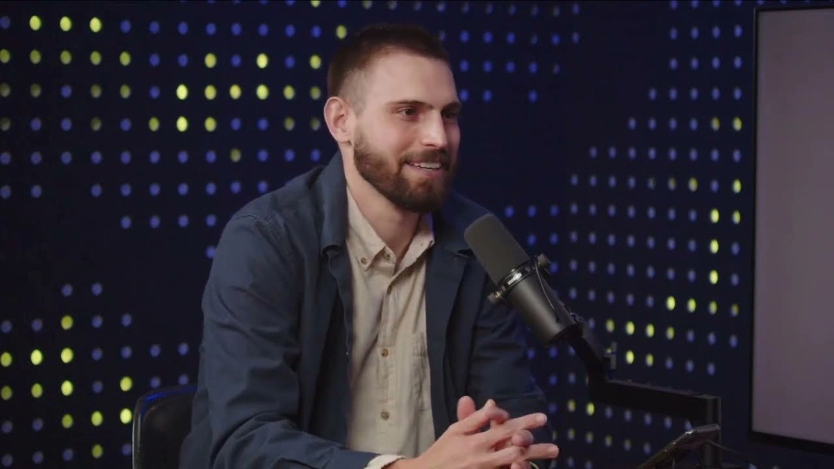 Bryan on camera in a podcast studio